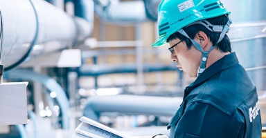 パナソニック環境エンジニアリング株式会社 プラント施設内で書類に目を通すエンジニア